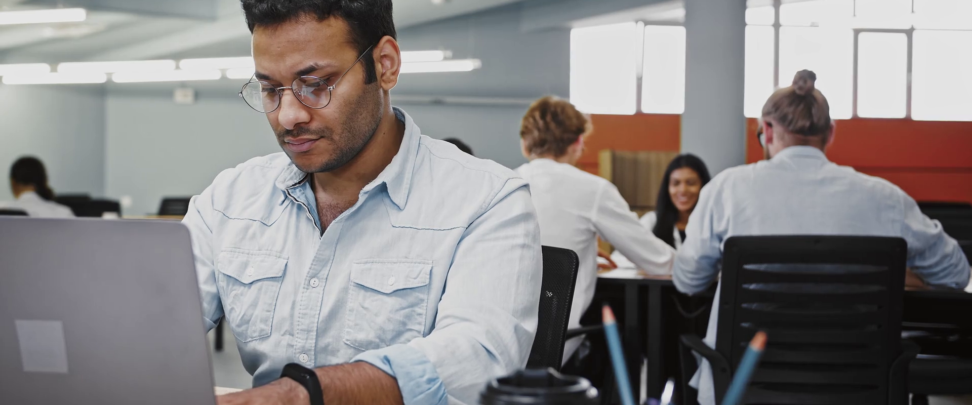 videoblocks-indian-man-employee-working-at-laptop-on-new-business-project-sitting-at-table-in-modern-office_bz-d4cqlf__thumbnail-1080_01